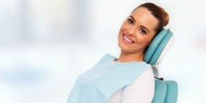 Young female patient smiling in the dental chair
