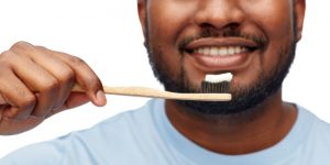 man with a toothbrush that has toothpste on it